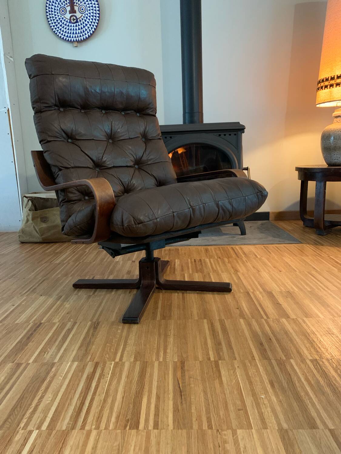 Vintage leather armchair with wooden armrests