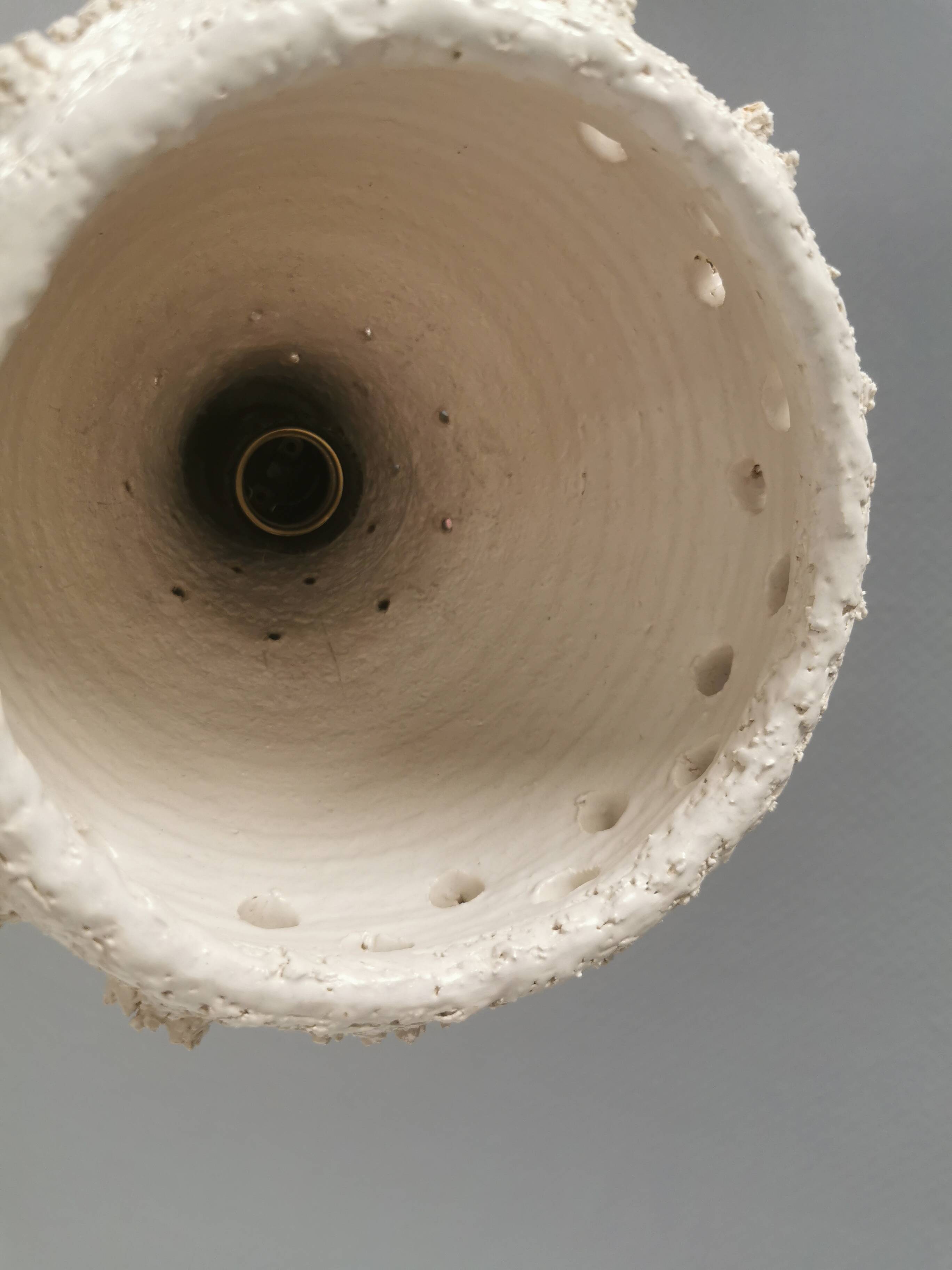 Ceramic hanging lamp in creamy white color that almost looks like a corral