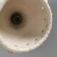 Ceramic hanging lamp in creamy white color that almost looks like a corral