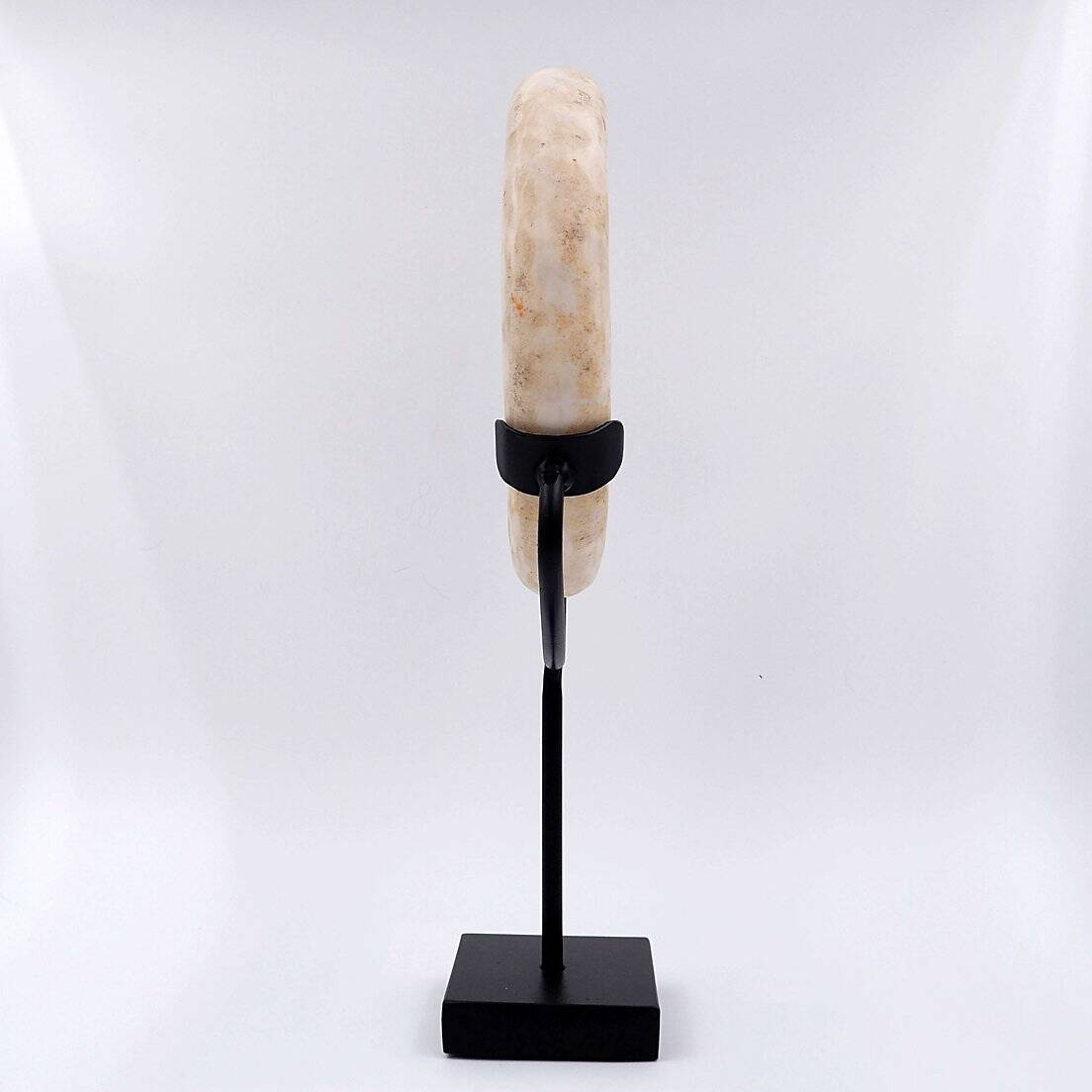 "Wamayuwa" Boiken coin in hand-carved shell mounted on a black metal stand