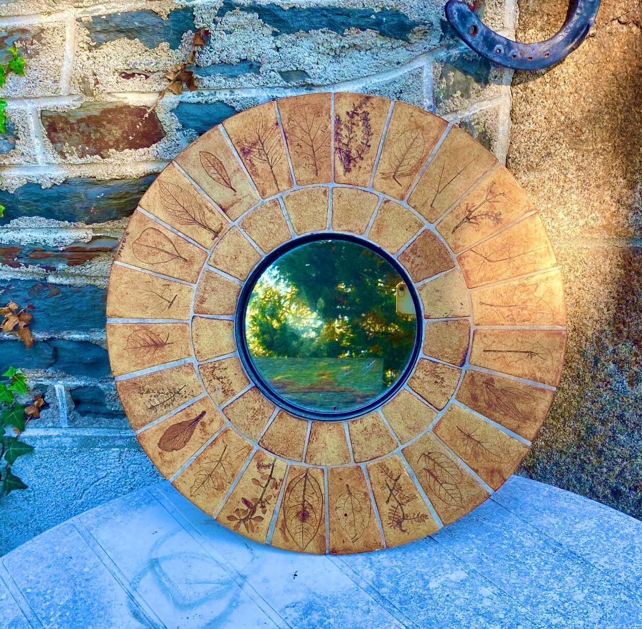 Round ceramic mirror decorated with leaves, signed Roger Capron, 50