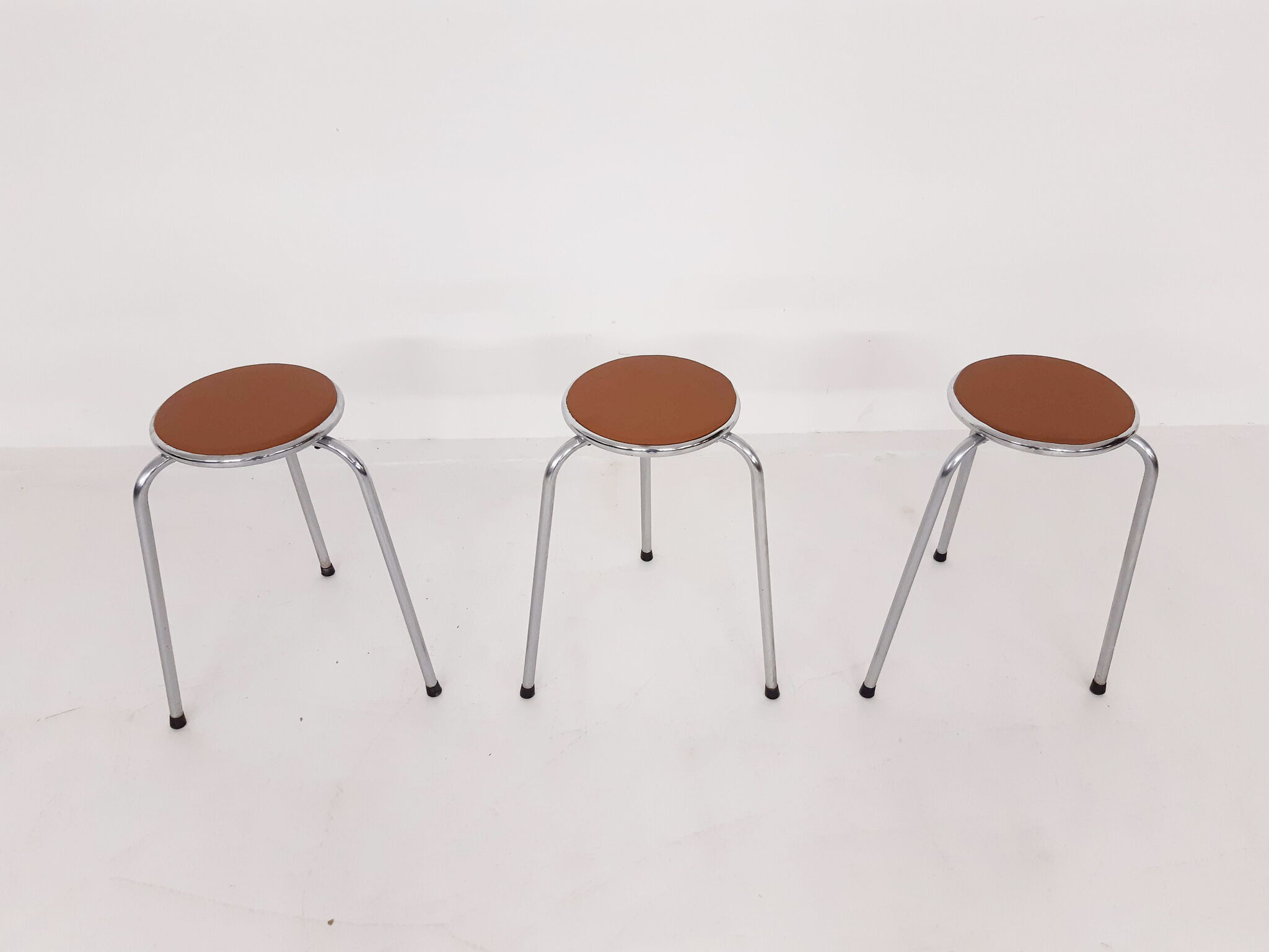 Set of 3 chrome stools with cognac leather seating, 1960's
