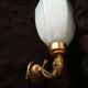 Golden brass wall light with glass tulip - dolphin pattern bathroom lamp