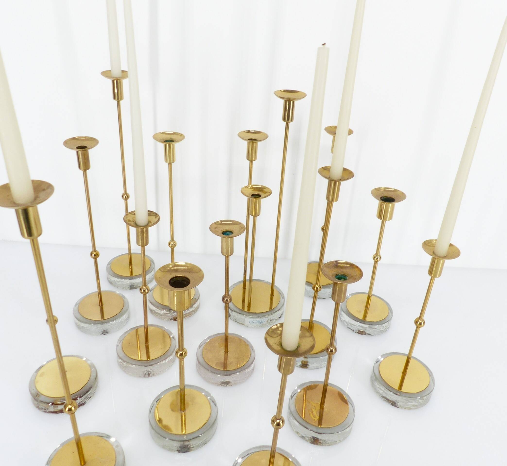Set of 15 Scandinavian candle holders in brass and glass, Gunnar Ander, Ystad Met