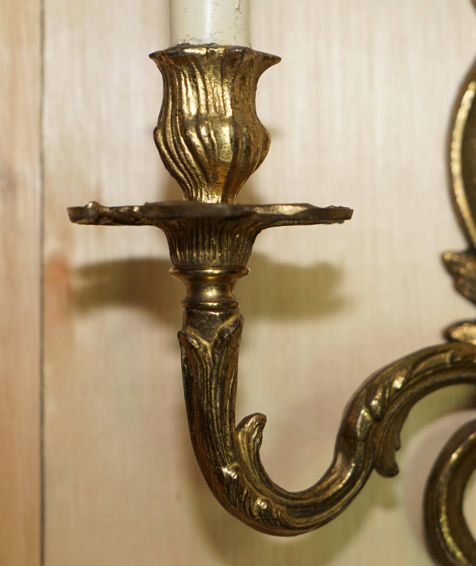 Pair of antique wall sconces from the 1920s in gilded bronze.
