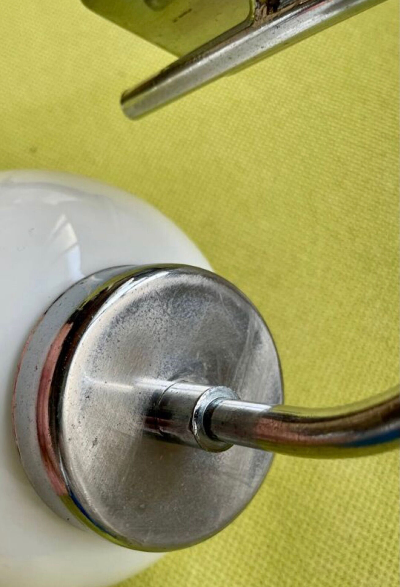 Pair of chrome metal wall lights with white glass globe.