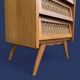 Vintage rattan chest of drawers with splayed legs from the 1950s.