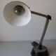 Super Chrome old articulated metal desk lamp on workshop decor base