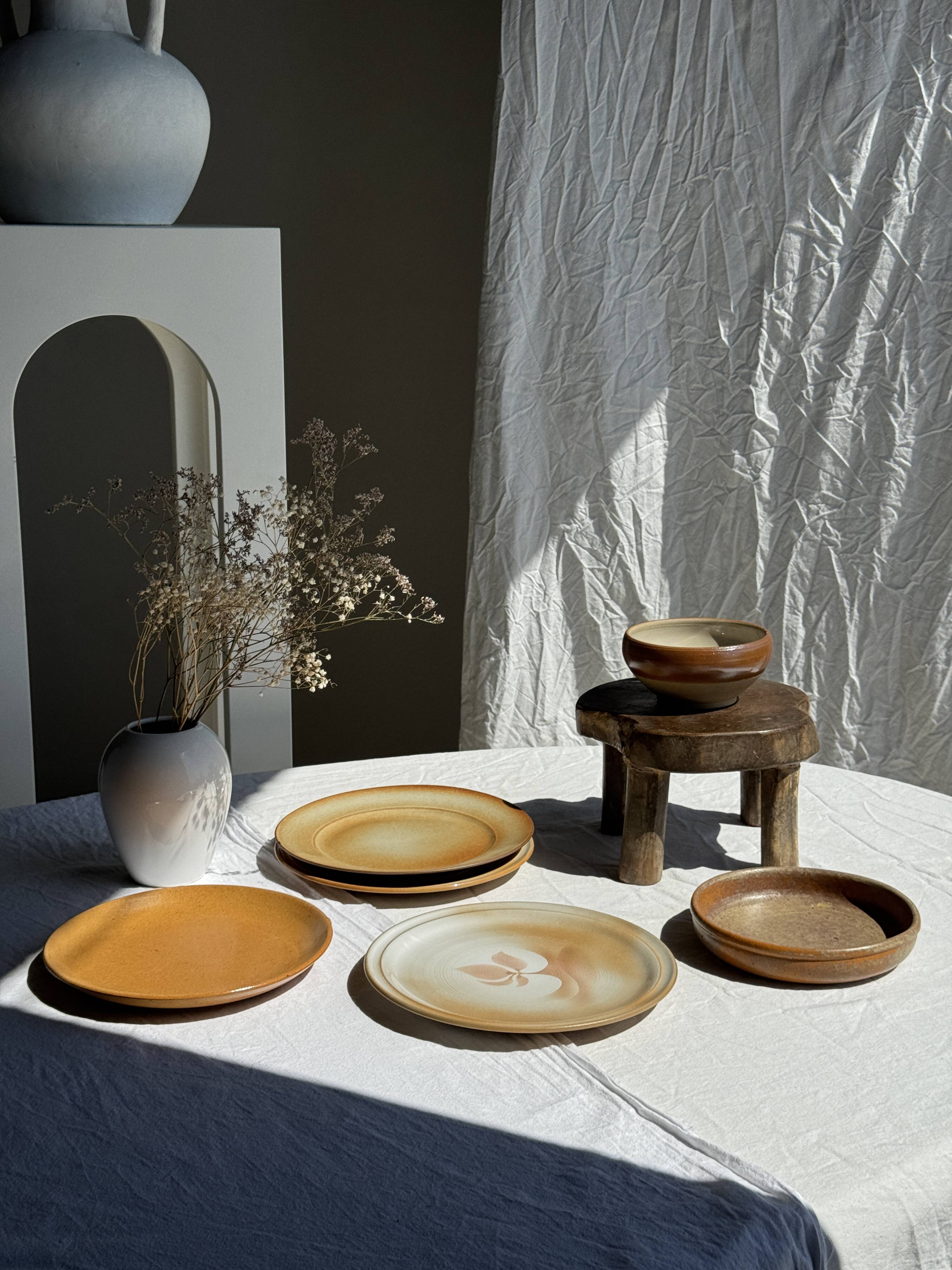 Set of 4 vintage stoneware plates, including 2 with floral motifs