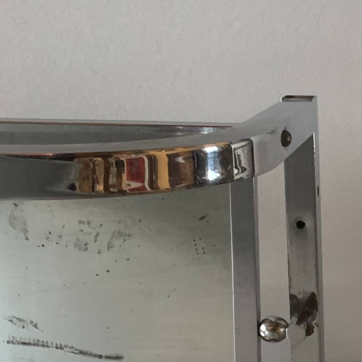 Vintage wall-mounted coat rack in chrome metal with integrated mirror and hat rack