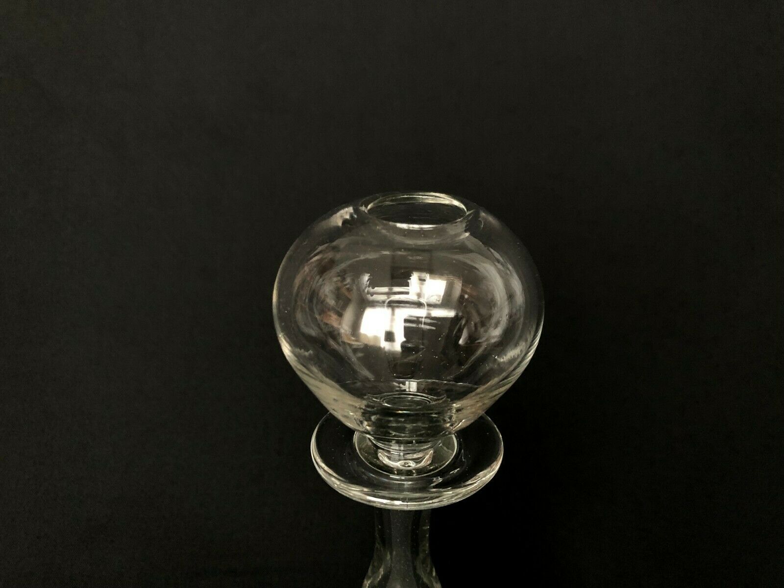 Glass oil lamp blows on foot shower