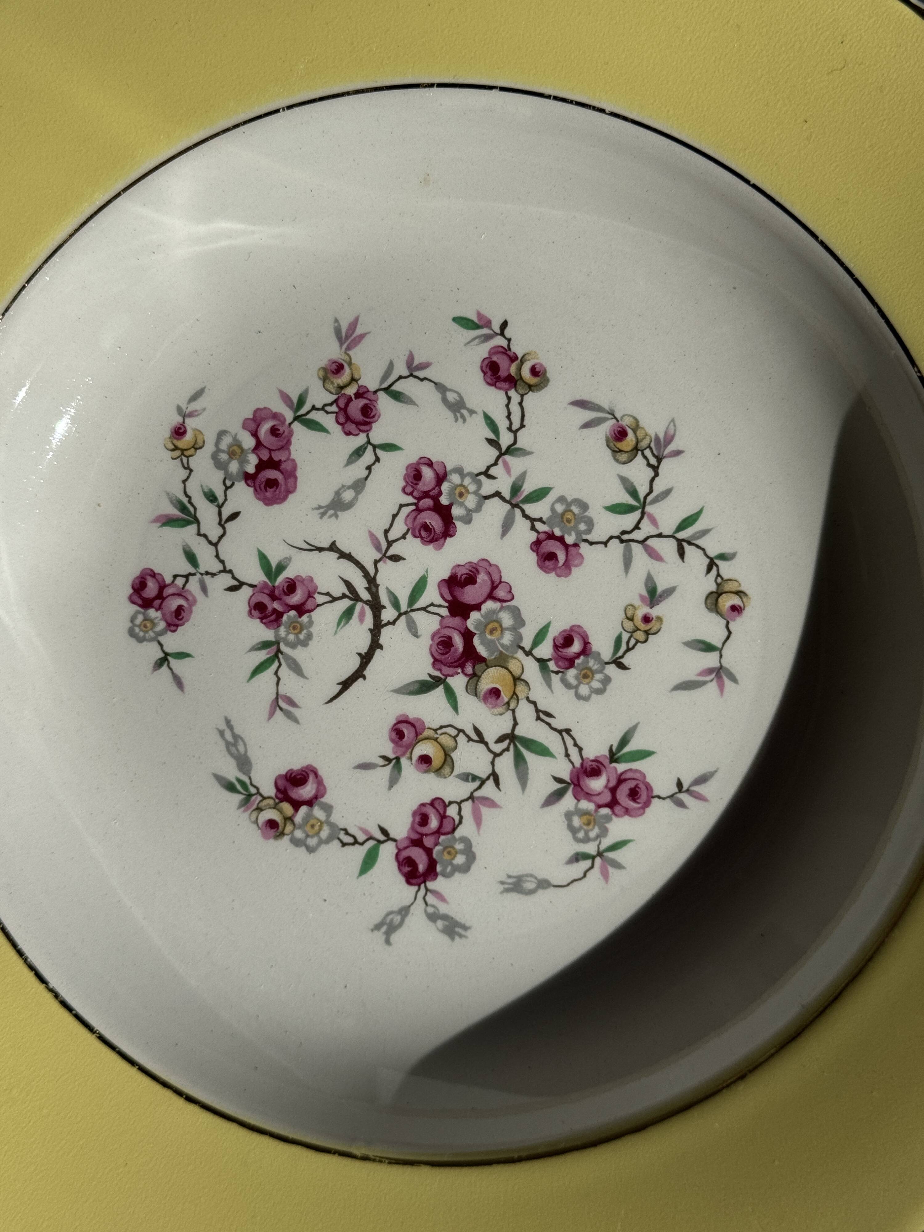 Set of 9 large vintage yellow deep plates with pink flowers and a gold rim.