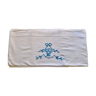 Hand embroidered sheet with blue flower basket pattern