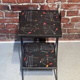 Black metal server and earthenware tiles with geometric patterns