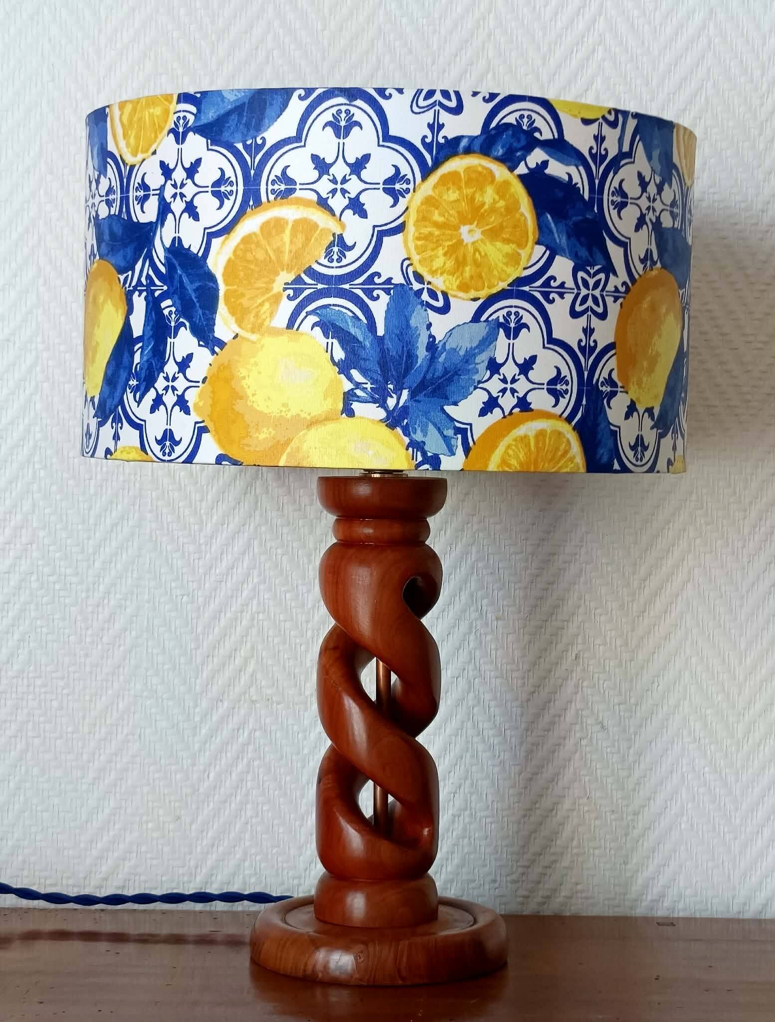 Turned wooden lamp with a lampshade featuring lemon tiles.
