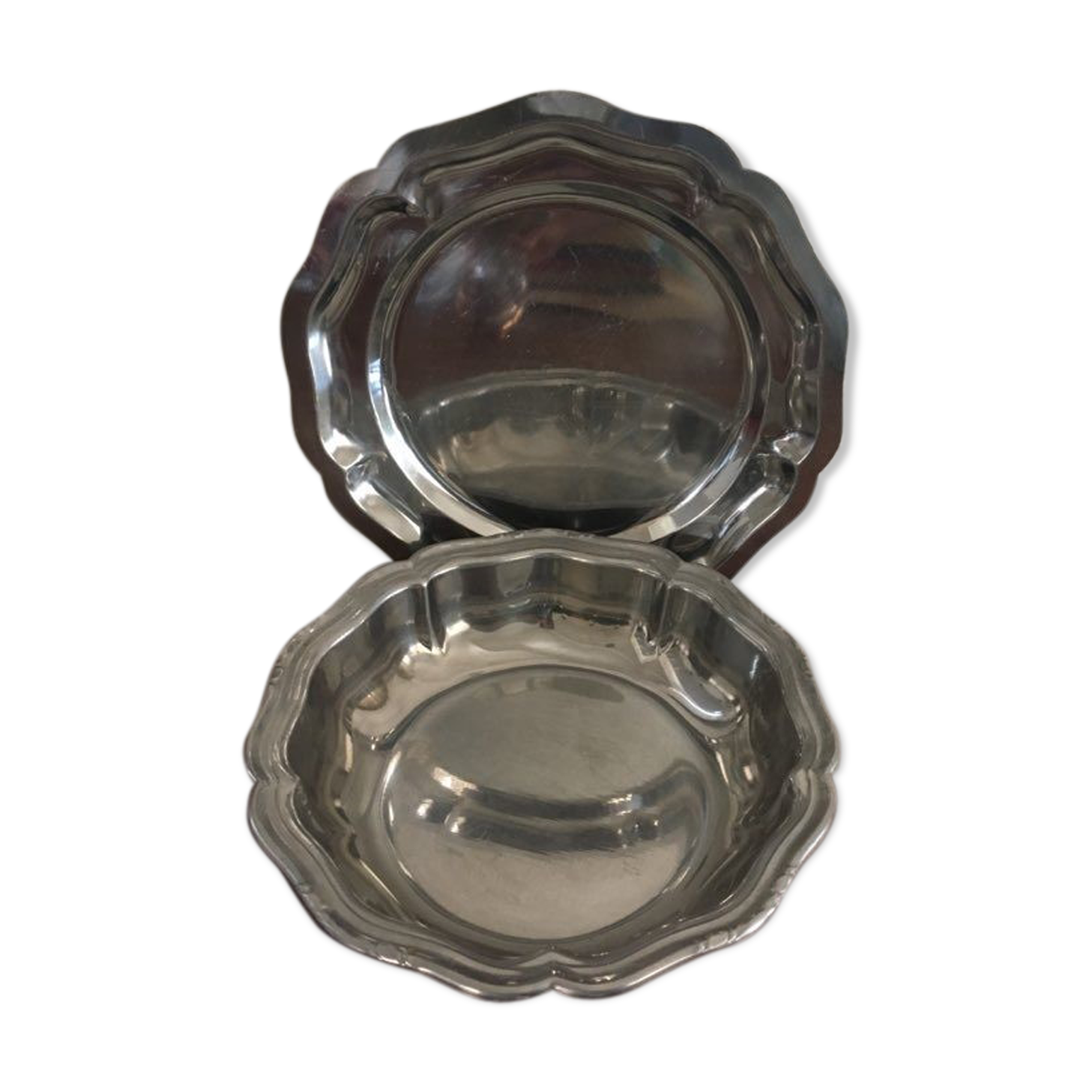 Two matching round dishes in stainless steel