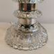 Table lamp made of transparent crystal glass and silver colored spacers.