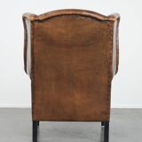 Large and comfortable sheepskin leather wingback chair with black piping