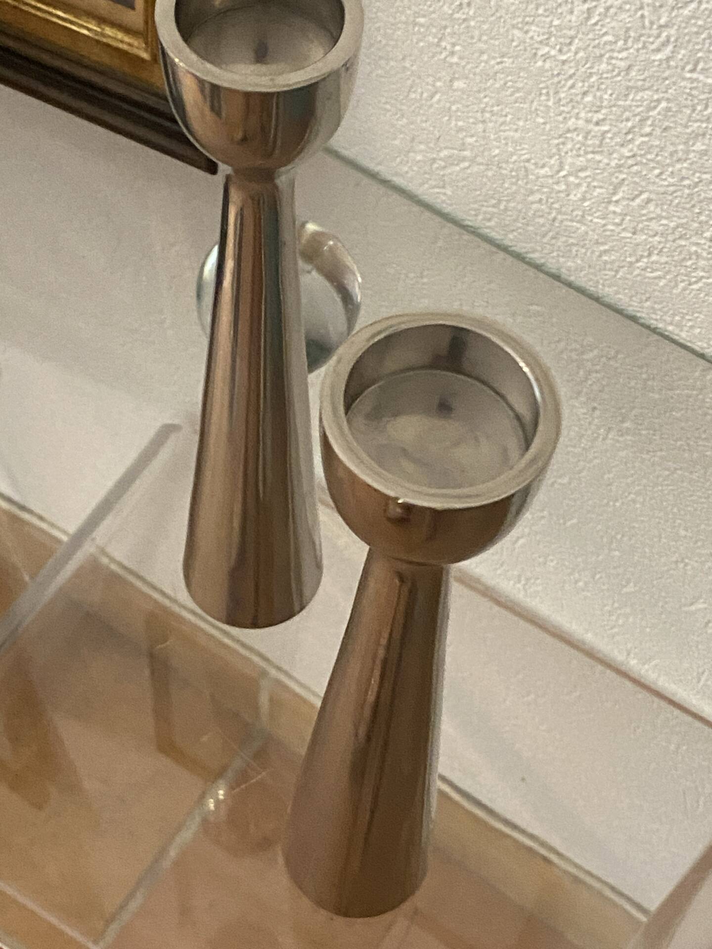 Pair of polished aluminium candlesticks