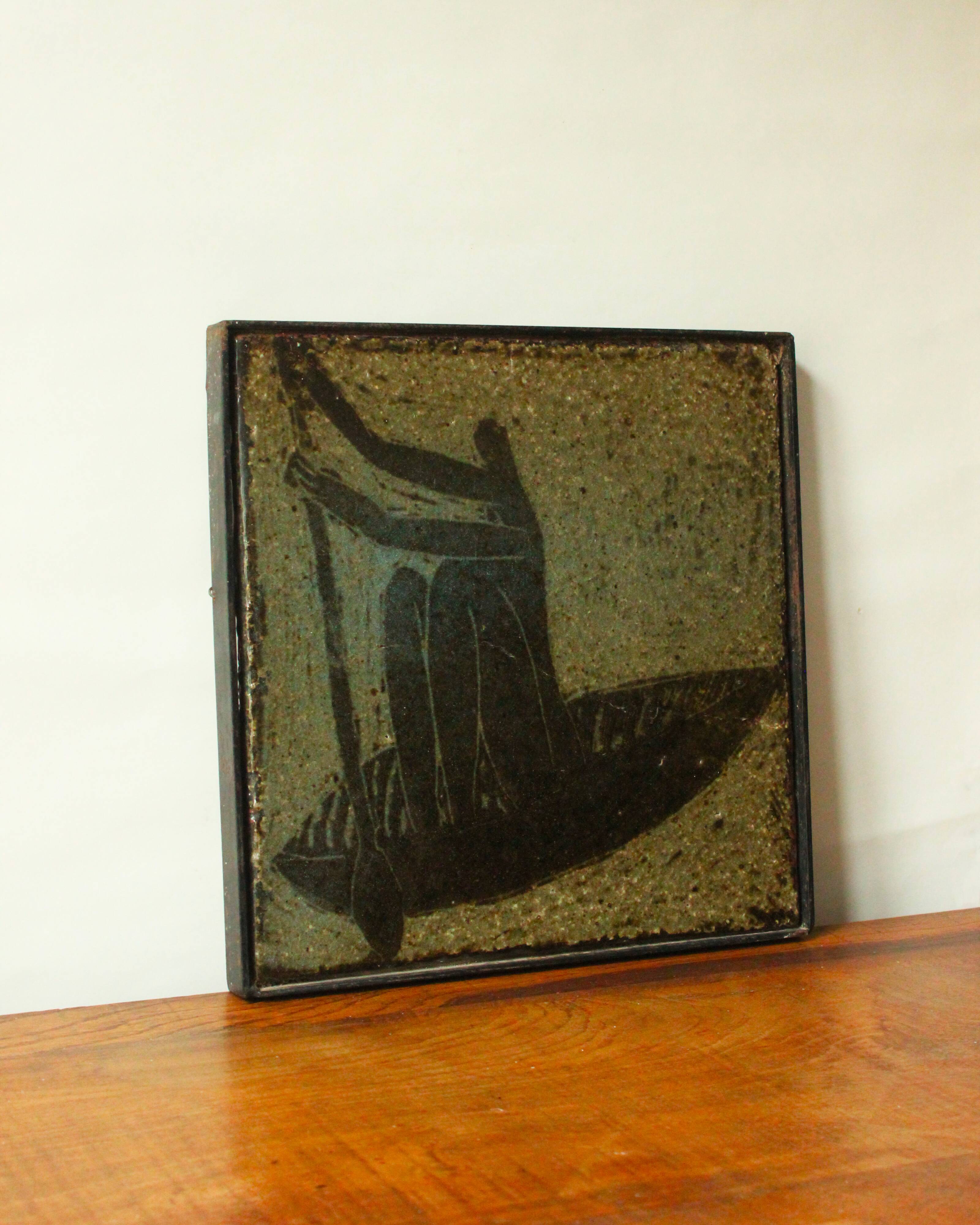 Glazed chamotte clay plaque in grey-green and black, decorated with a rower.