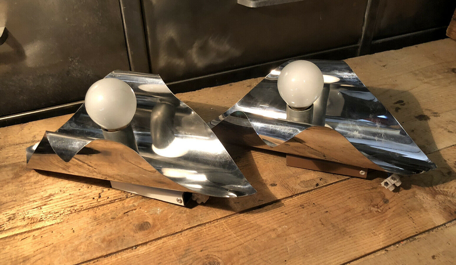 Pair space Age chrome metal wall appliques