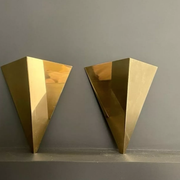 Pair of geometric vintage wall lamps in solid brass, France 1970.