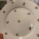 Dessert plate and porcelain dishes with a multicoloured floral pattern, vintage.