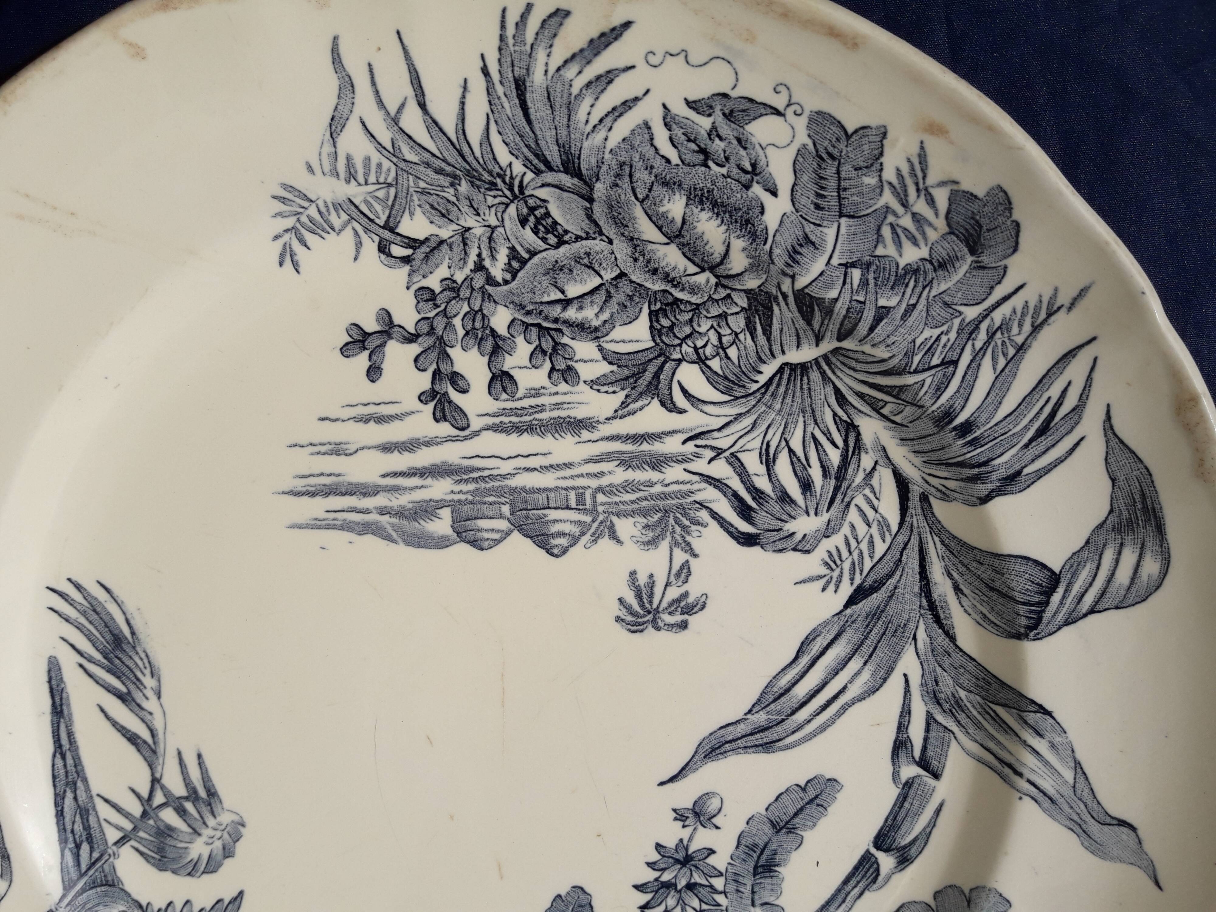 Plat rond en faïence de Longchamp modèle exotique diam 29,5 cm début XXème