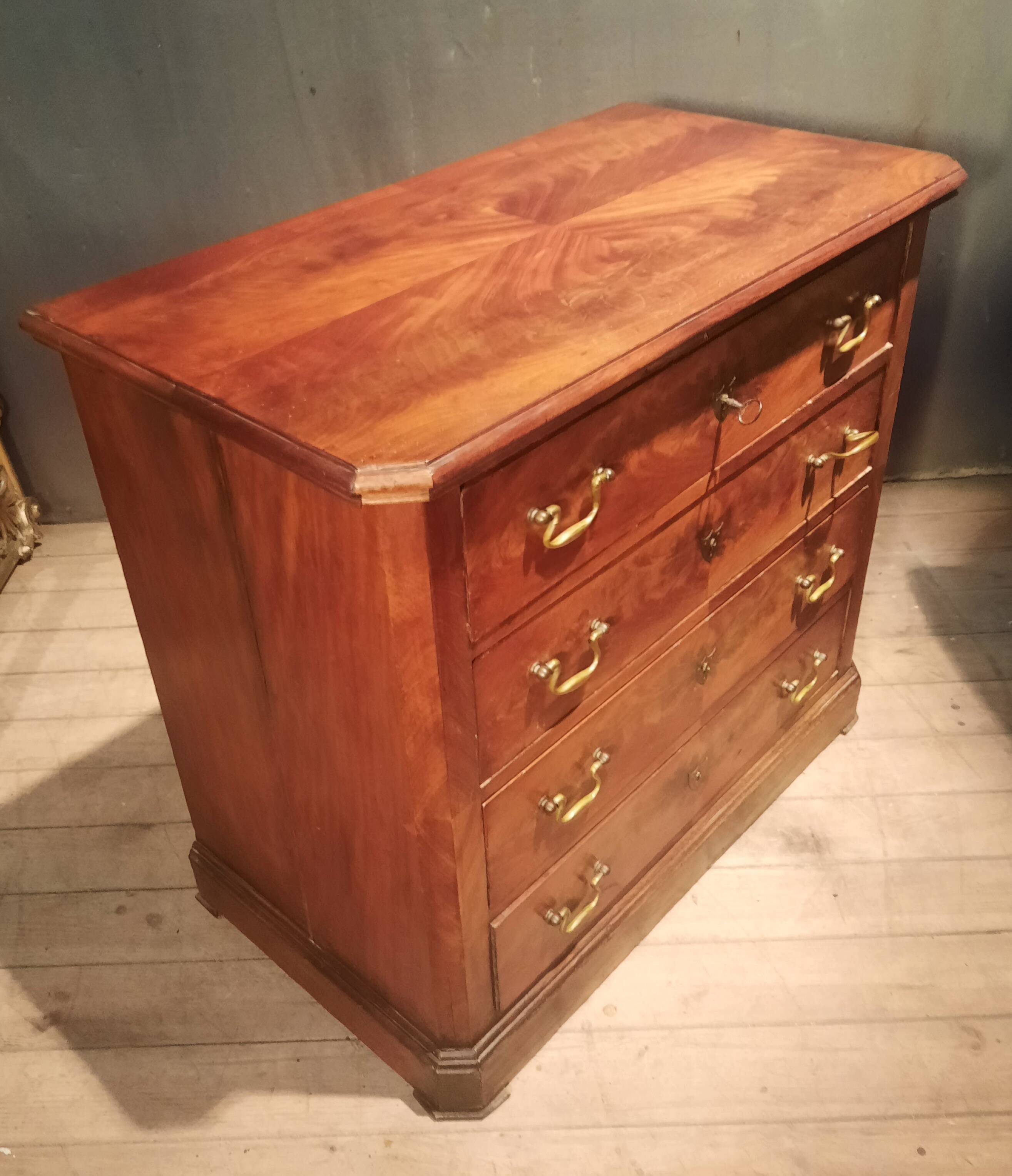 Small Louis Philippe chest of drawers with cut corners.