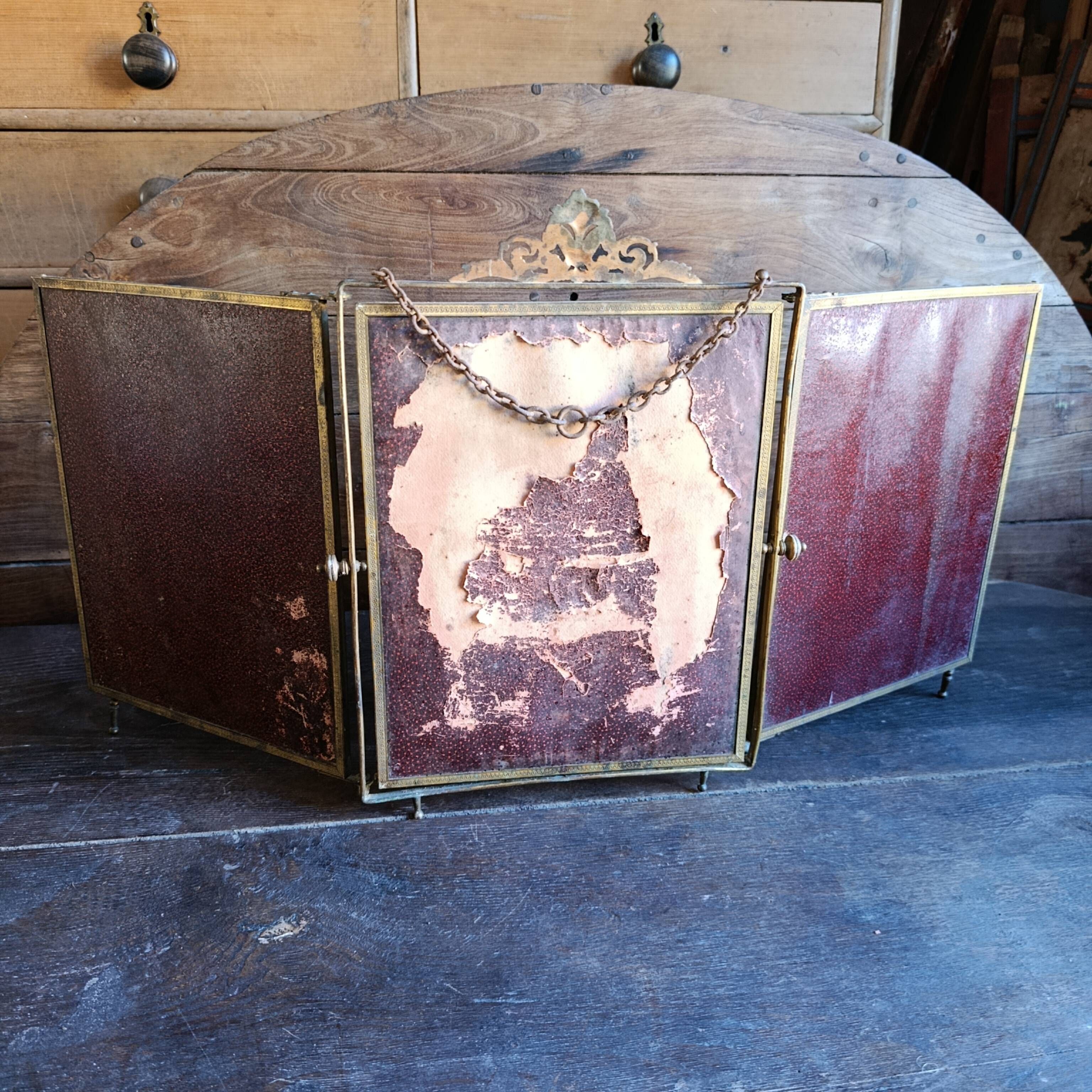 Antique French gilt metal triptych vanity mirror with floral crest