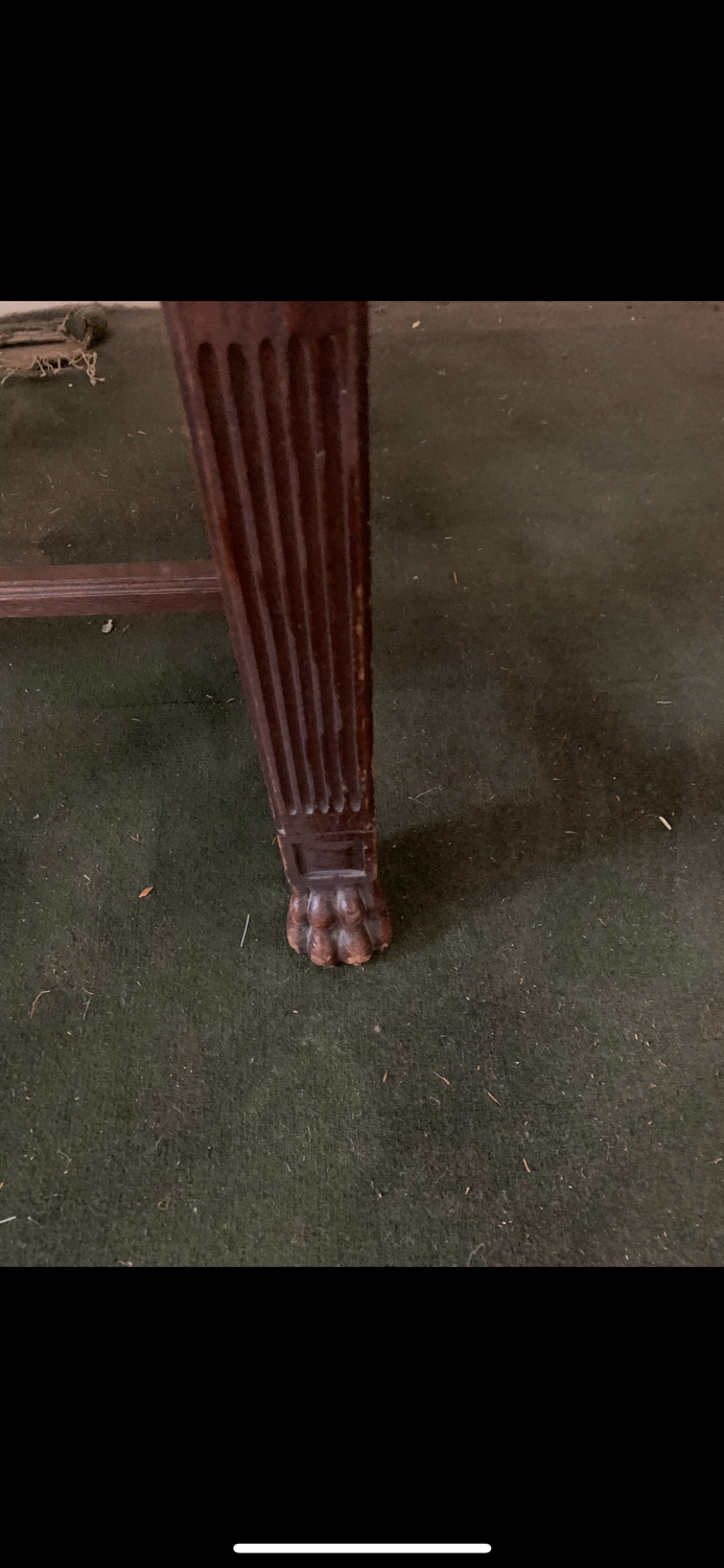 Antique armchair in carved wood with a straw seat.
