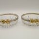 Set of 2 glass and metal bowls with a bow design.