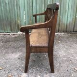 Duo of old solid oak benches with backs and armrests.