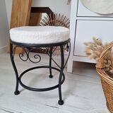 Black iron stool/pouf with its boucle fabric cushion.