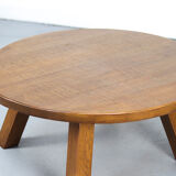 Large rustic vintage coffee table in a round brutalist style.