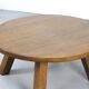Large rustic vintage coffee table in a round brutalist style.
