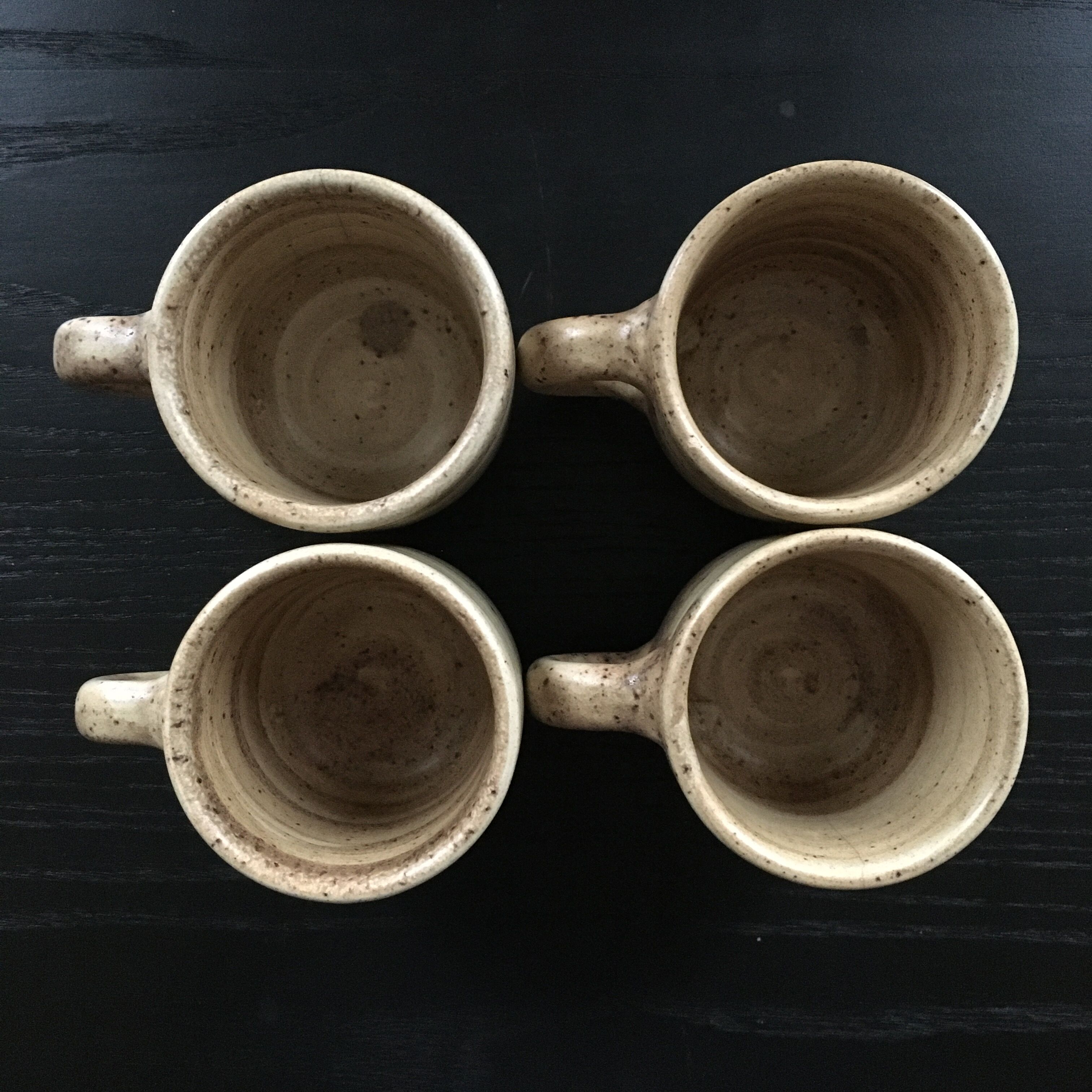 Set of 4 beige stoneware mugs.