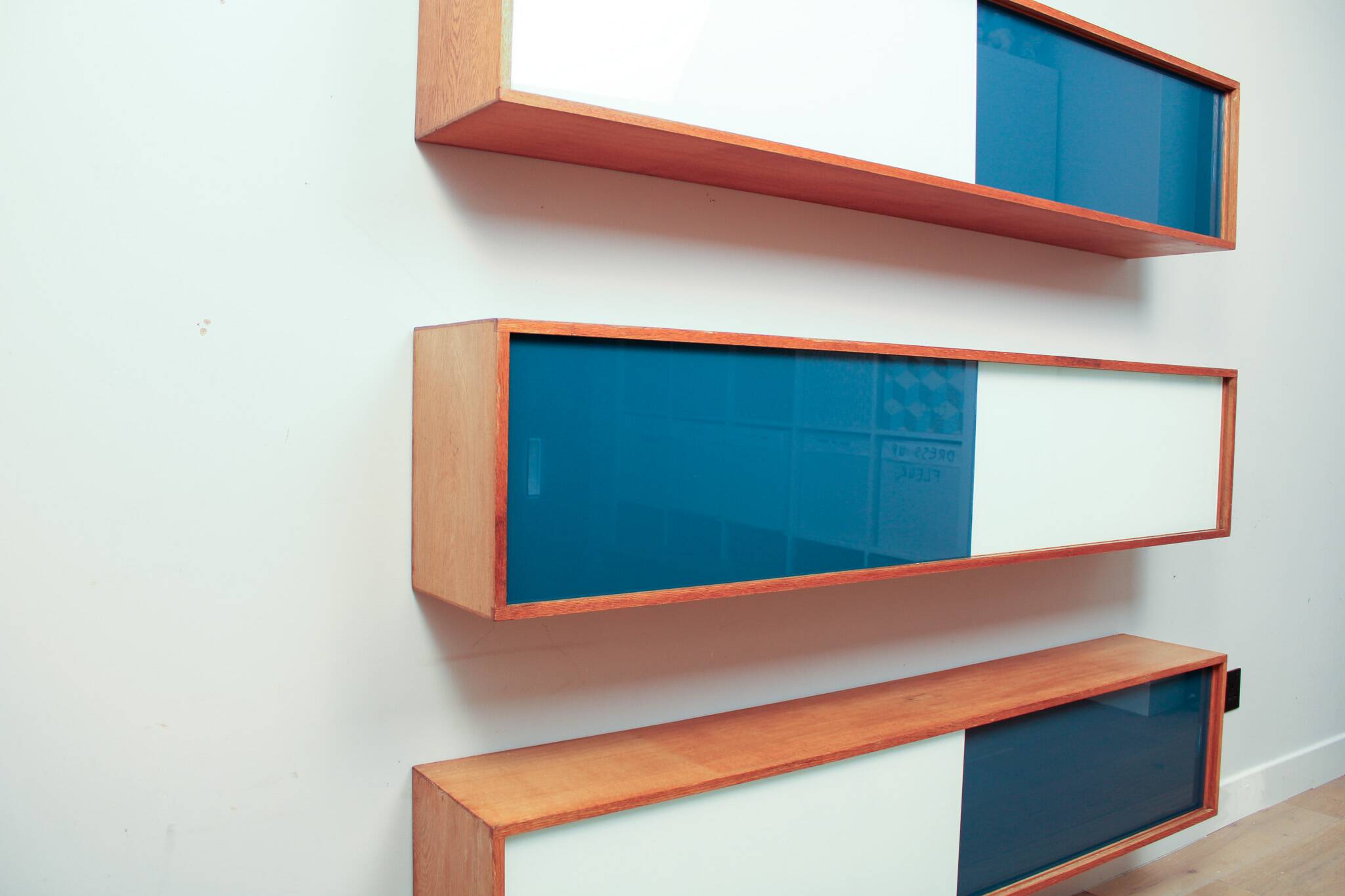 Vintage mid-century wall hung oak cabinets, blue & white sliding glass door