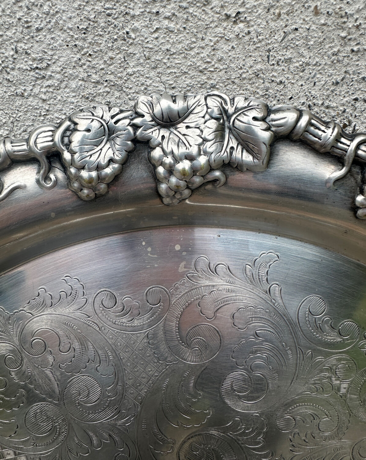 Antique round silver serving platter, grape motifs.