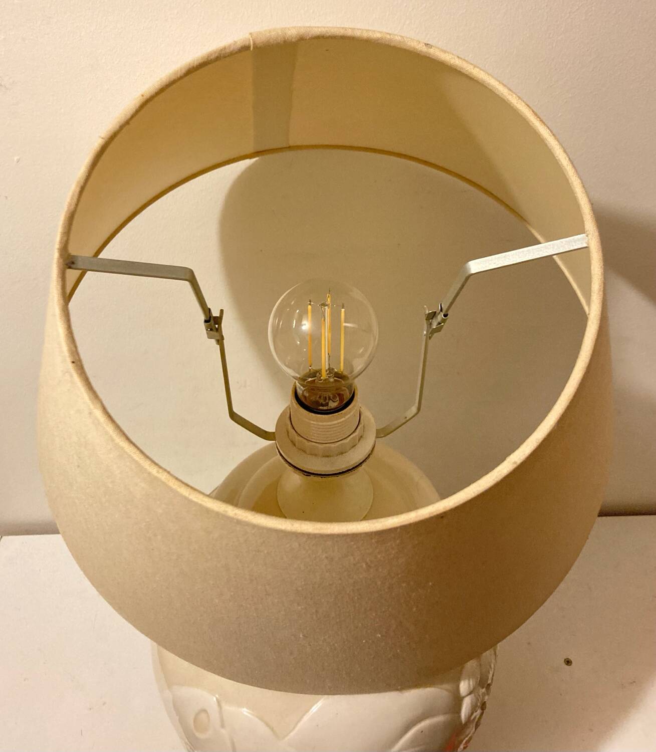 1980s ceramic table lamp with a wooden base and adjustable shade.