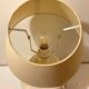 1980s ceramic table lamp with a wooden base and adjustable shade.