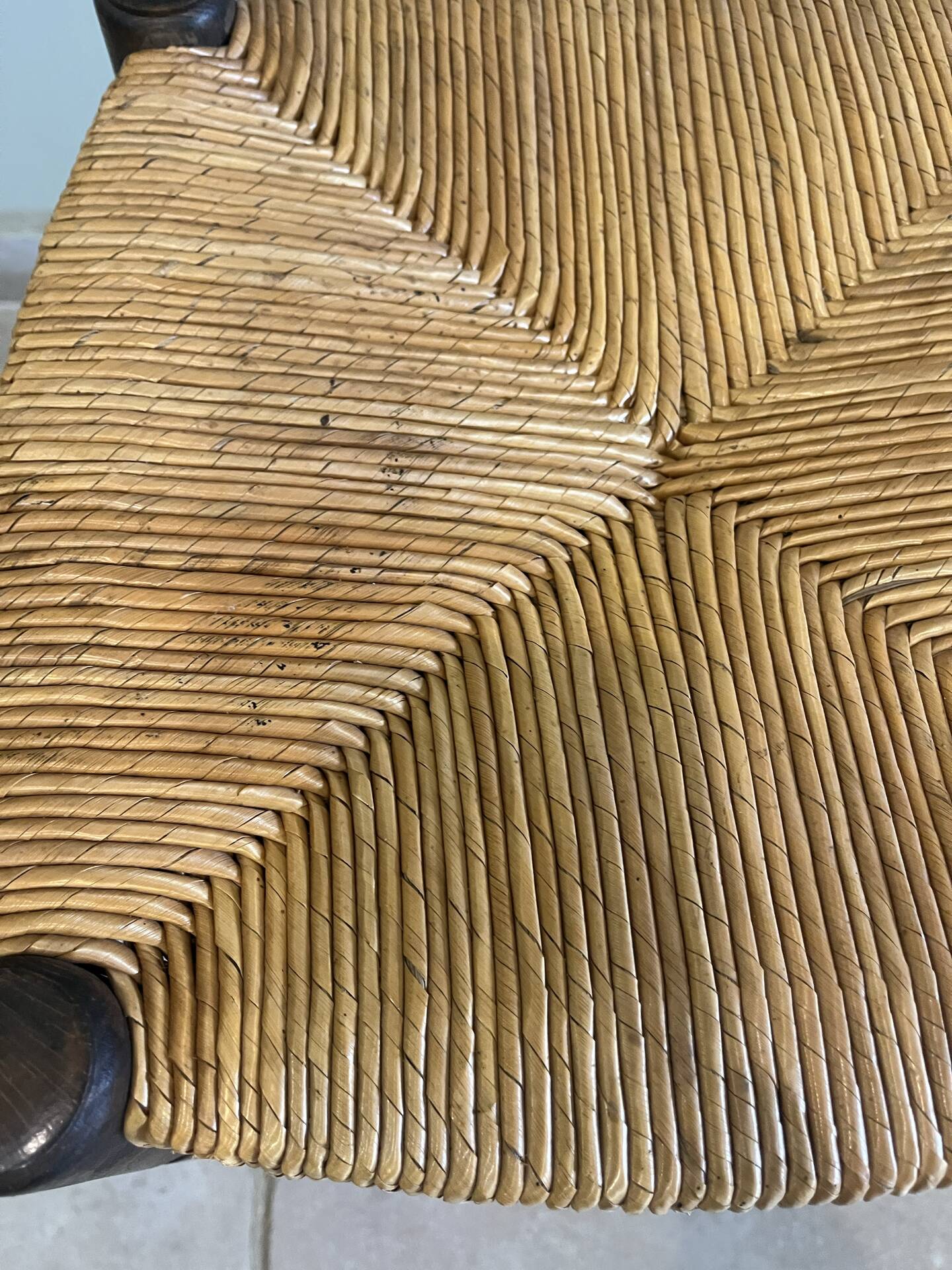 Wooden stool with a straw seat