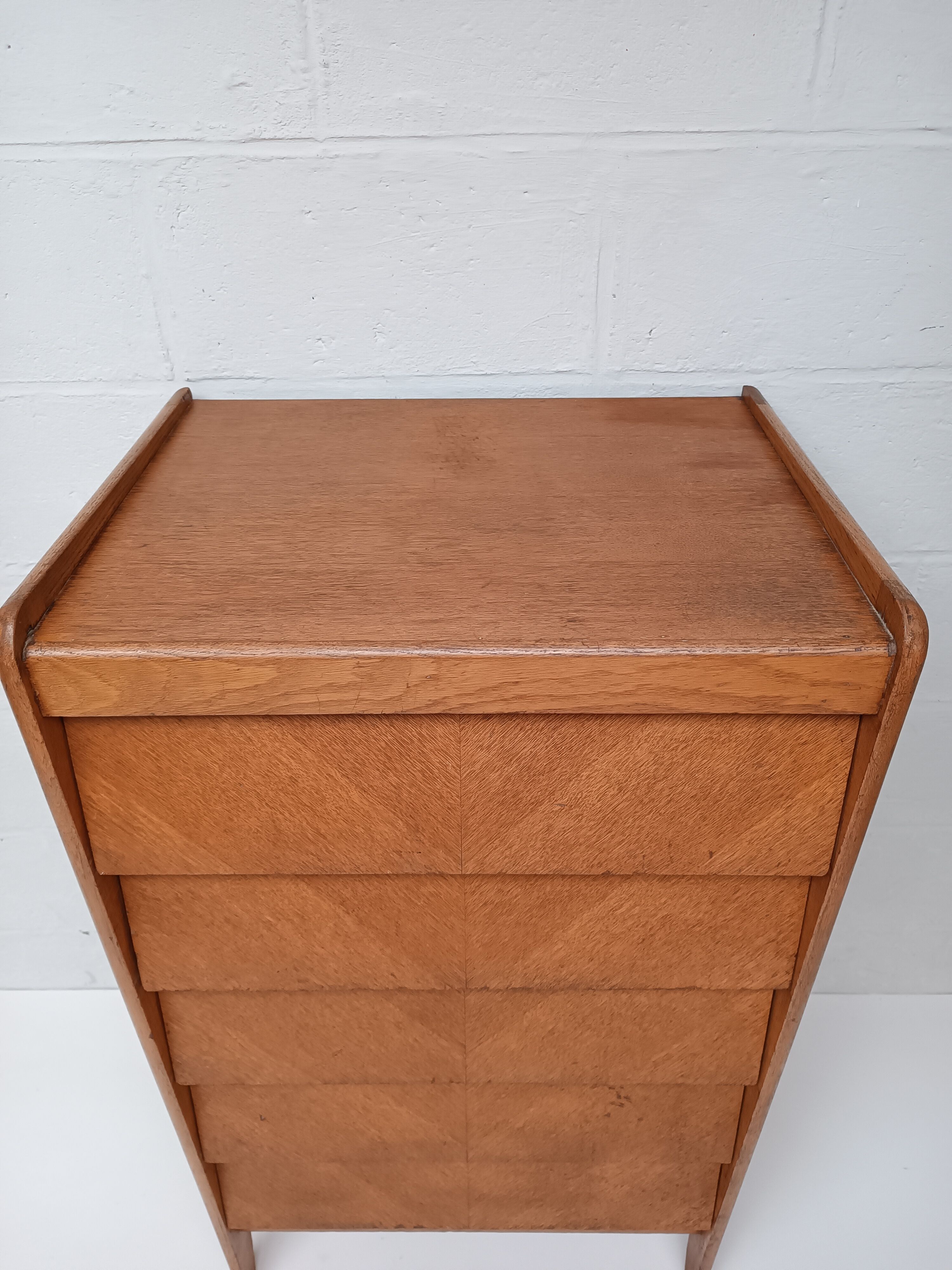 High wooden chest of drawers in the 50s