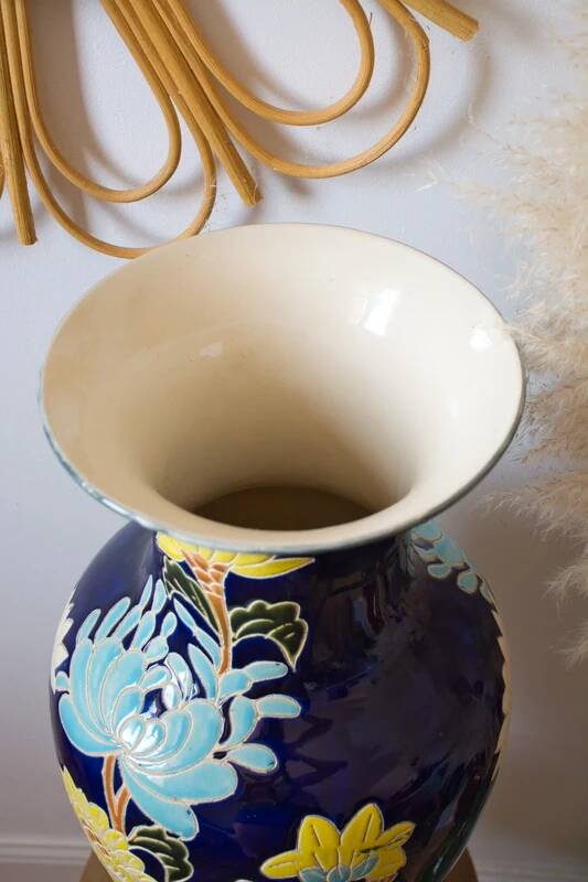 Large vintage vase with a floral relief motif.