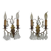 Pair of French antique brass double wall lights with assorted crystals.