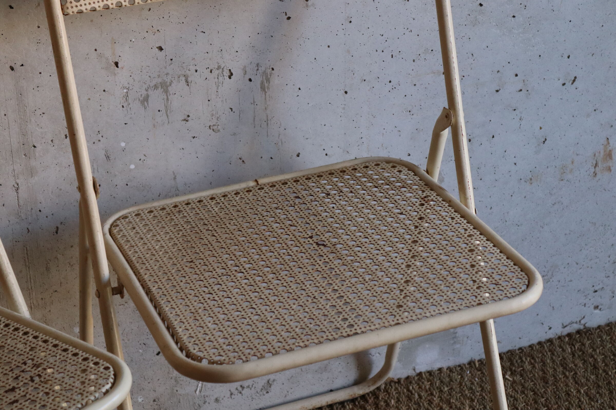 Two metal tanned folding chairs