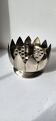 Picture of a lotus flower with a silver metal candlestick.