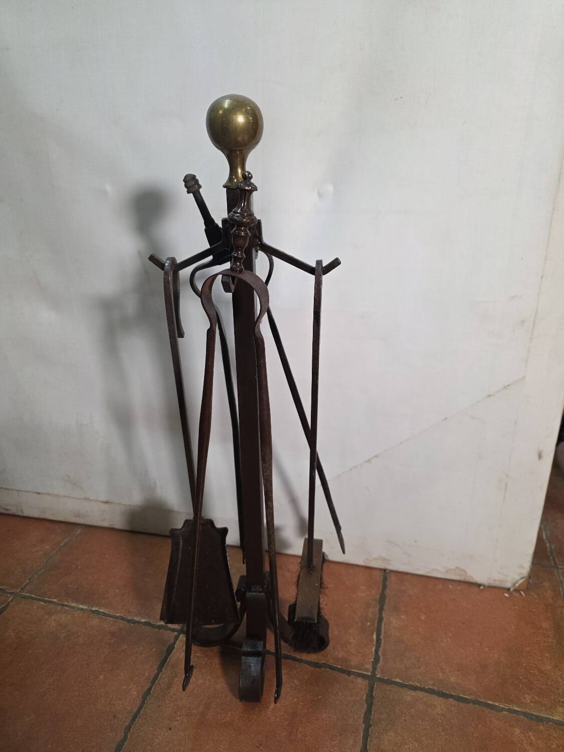 Antique fireplace set in solid wrought iron and brass.