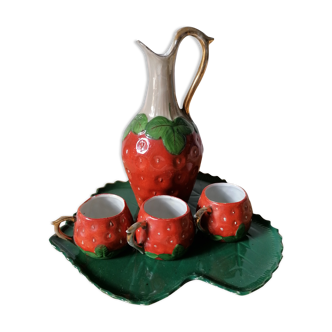 A strawberry-shaped liqueur service in mid-20th-old dabbling
