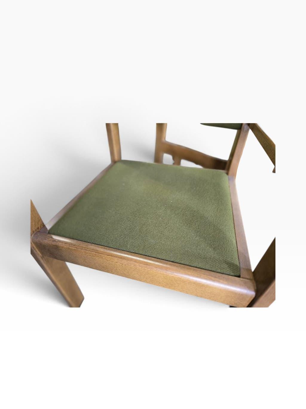 Vintage wooden chair with olive green seat and armrests.